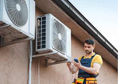 Technician inspecting outdoor air conditioning unit