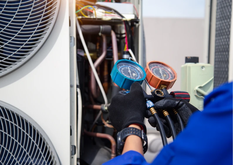 Technician checking HVAC system gauges