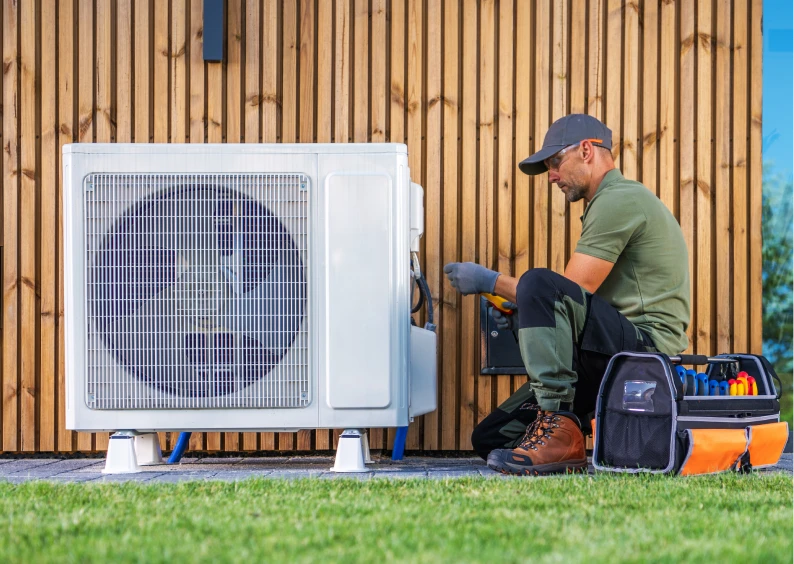 HVAC technician with tools servicing AC unit