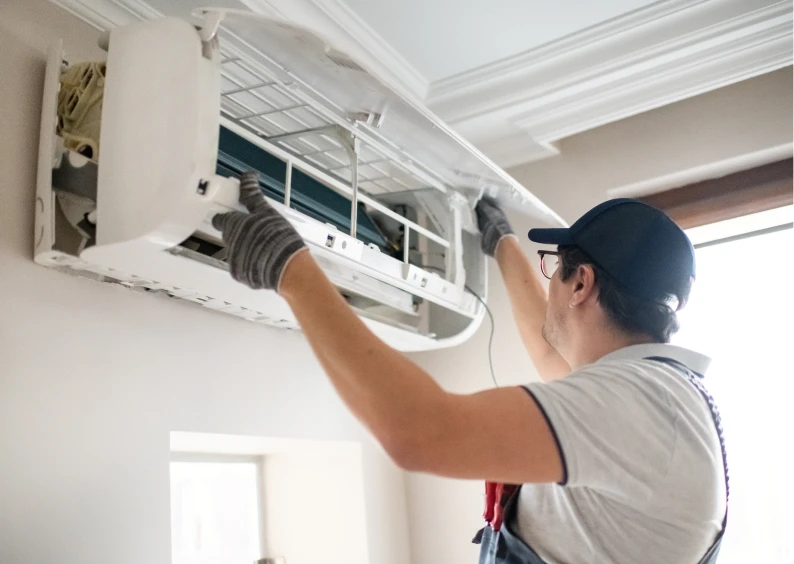 Technician repairing wall-mounted air conditioner