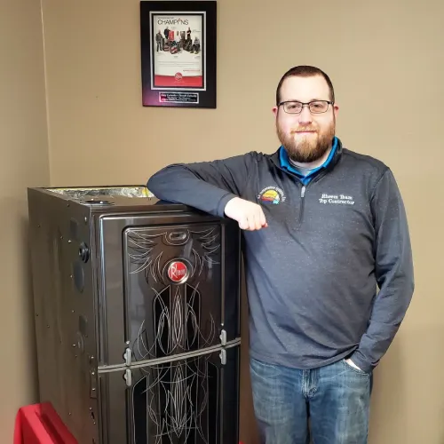 Man standing beside a metal furnace