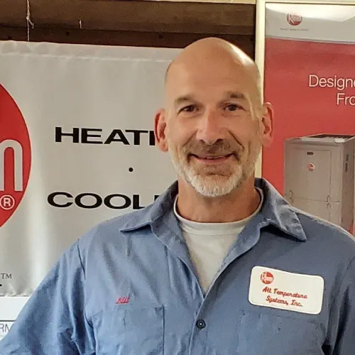 HVAC technician with company banner
