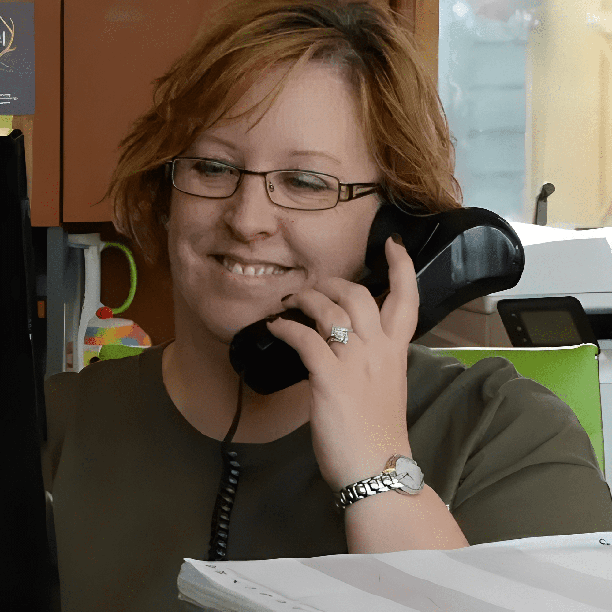 Woman talking on the phone, smiling.